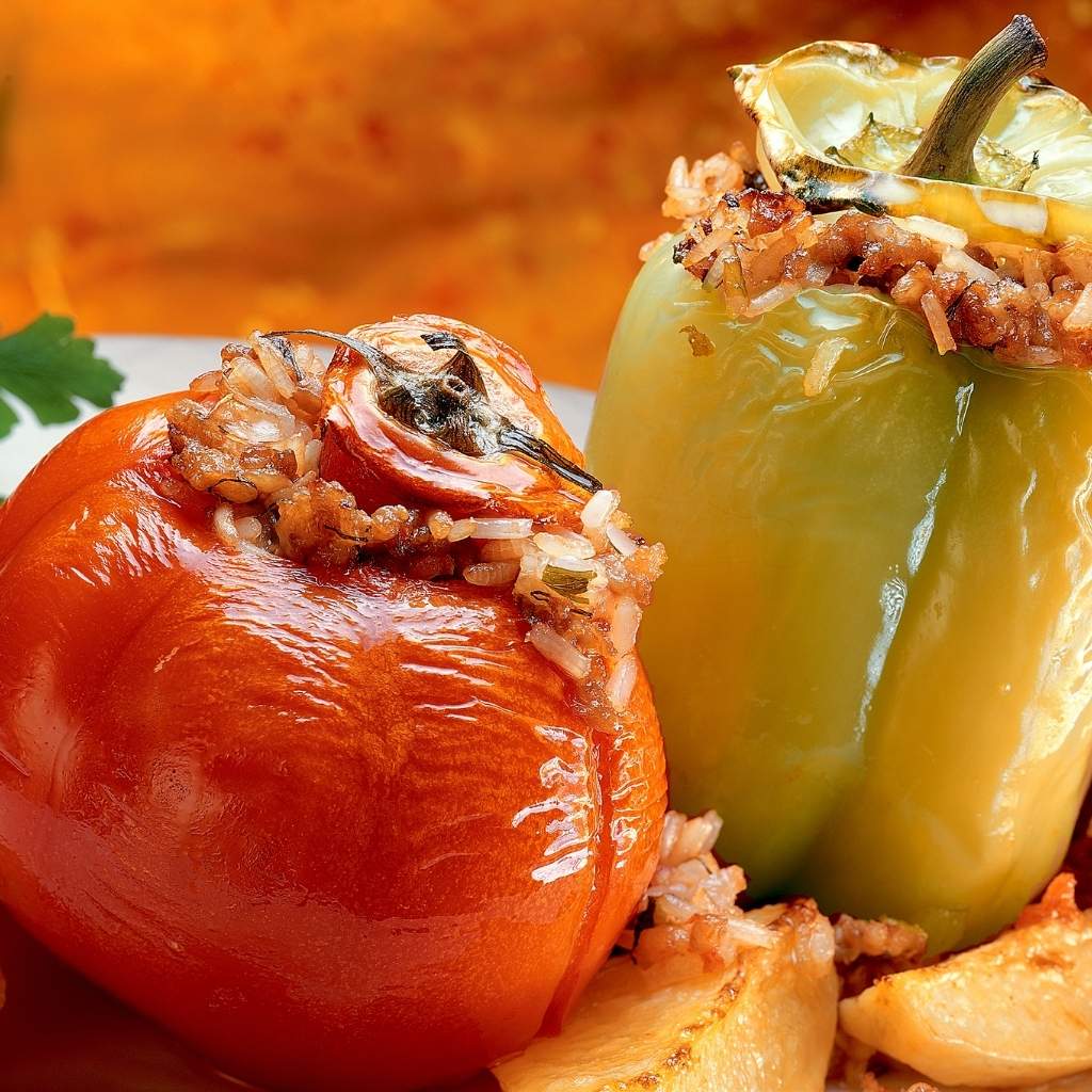 Gemista is a traditional Cretan dish stuffed with vegetables like tomatoes, bell peppers, and zucchini