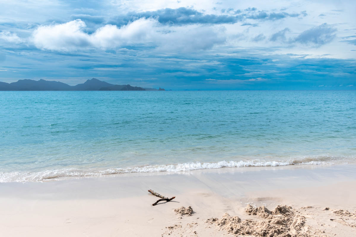 The tranquil turquoise waves at Sandy Skull Beach in Langkawi provide a picturesque backdrop