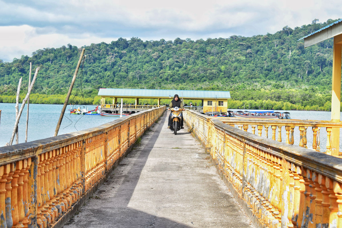 A local tourist driving on the bridge connecting Selat Bagan Nyior jetty