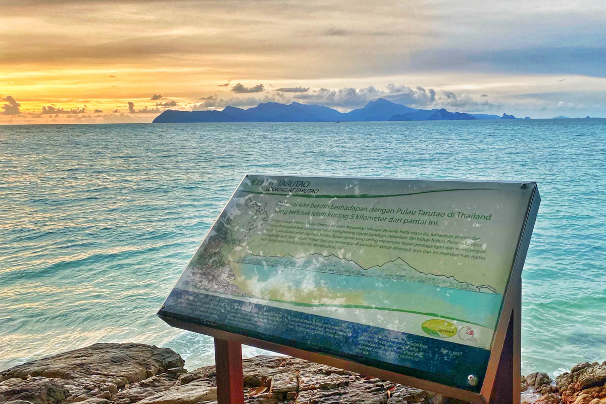 Overlooking Tarutao island, the plaque tells the history of Sandy Skull Beach