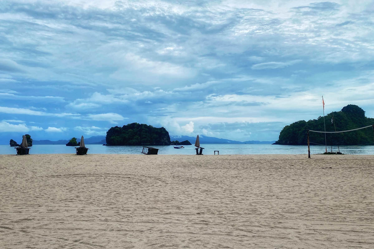 Panoramic view of Pantai Tanjung Rhu's turquoise waters and white sand beach