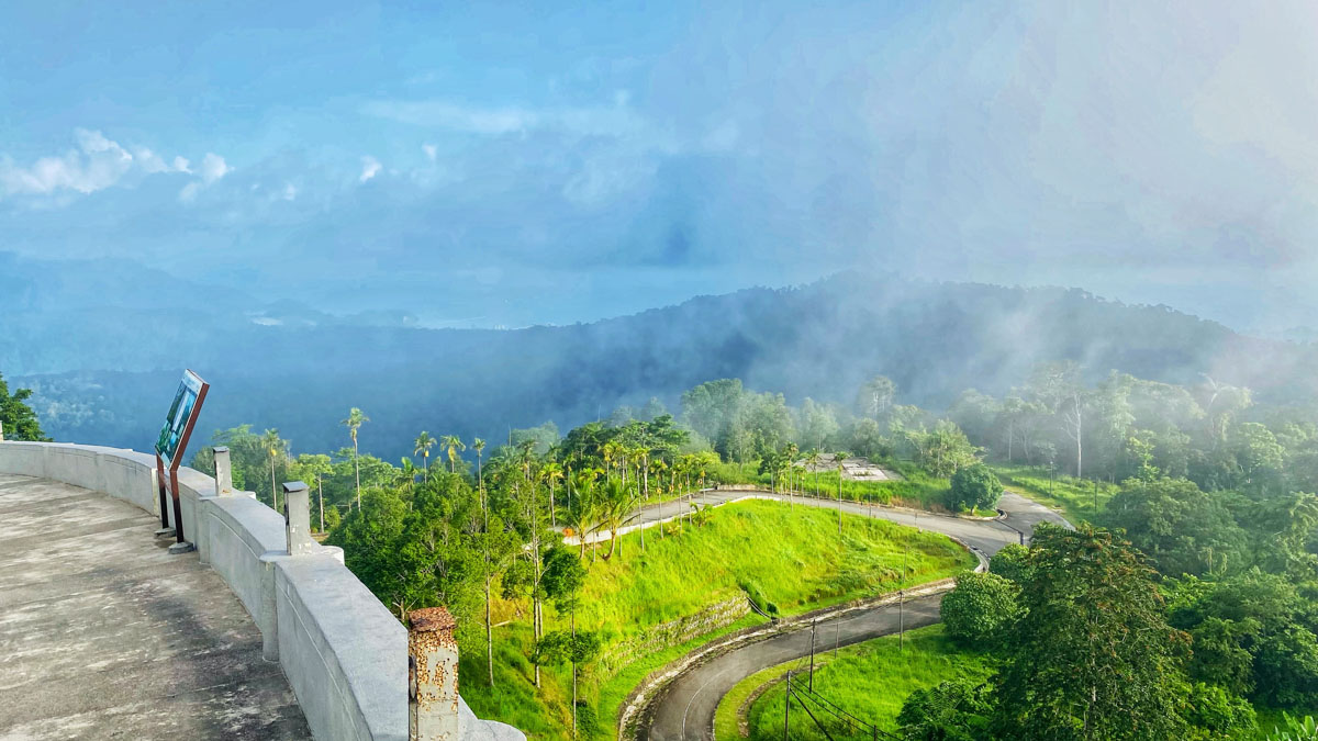 A breathtaking view of the surrounding landscape awaits you on Gunung Raya peak