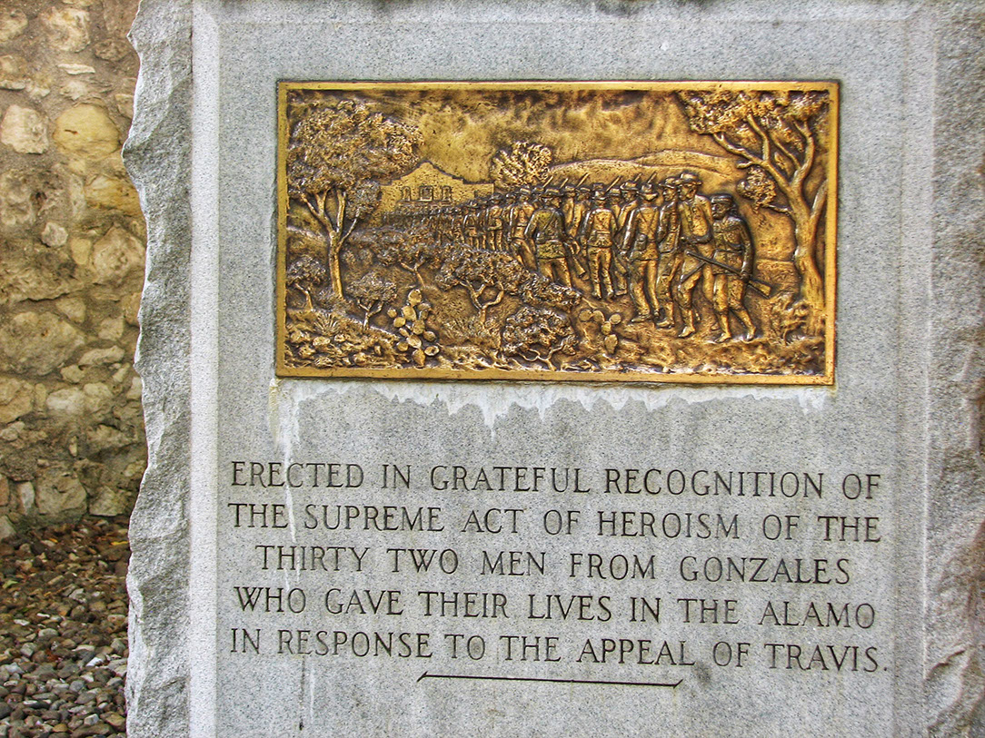 Alamo memorial gardens in San Antonio with a bronze relief of the men of Gonzales