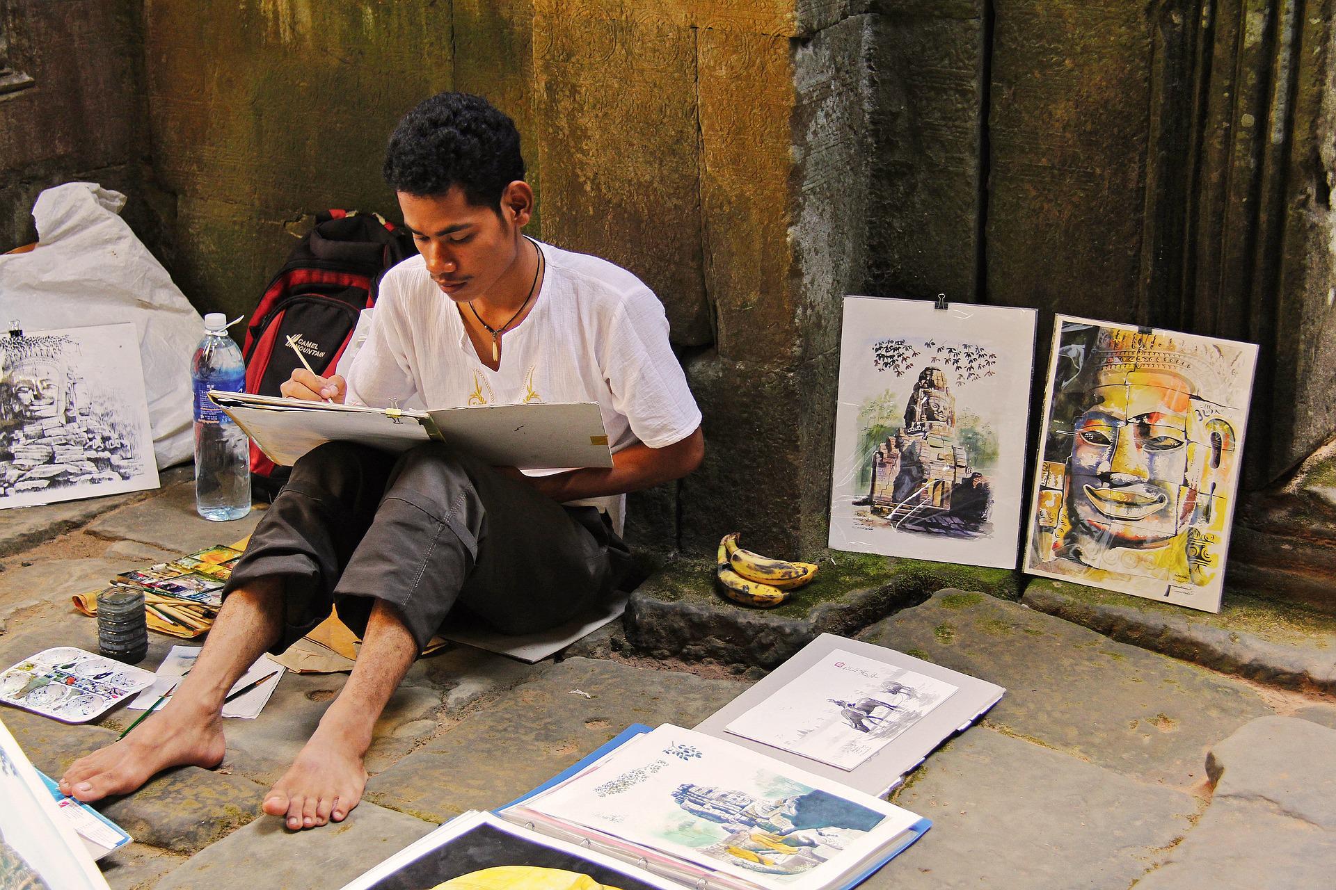 A street artist working on his art pieces in Siem Reap market