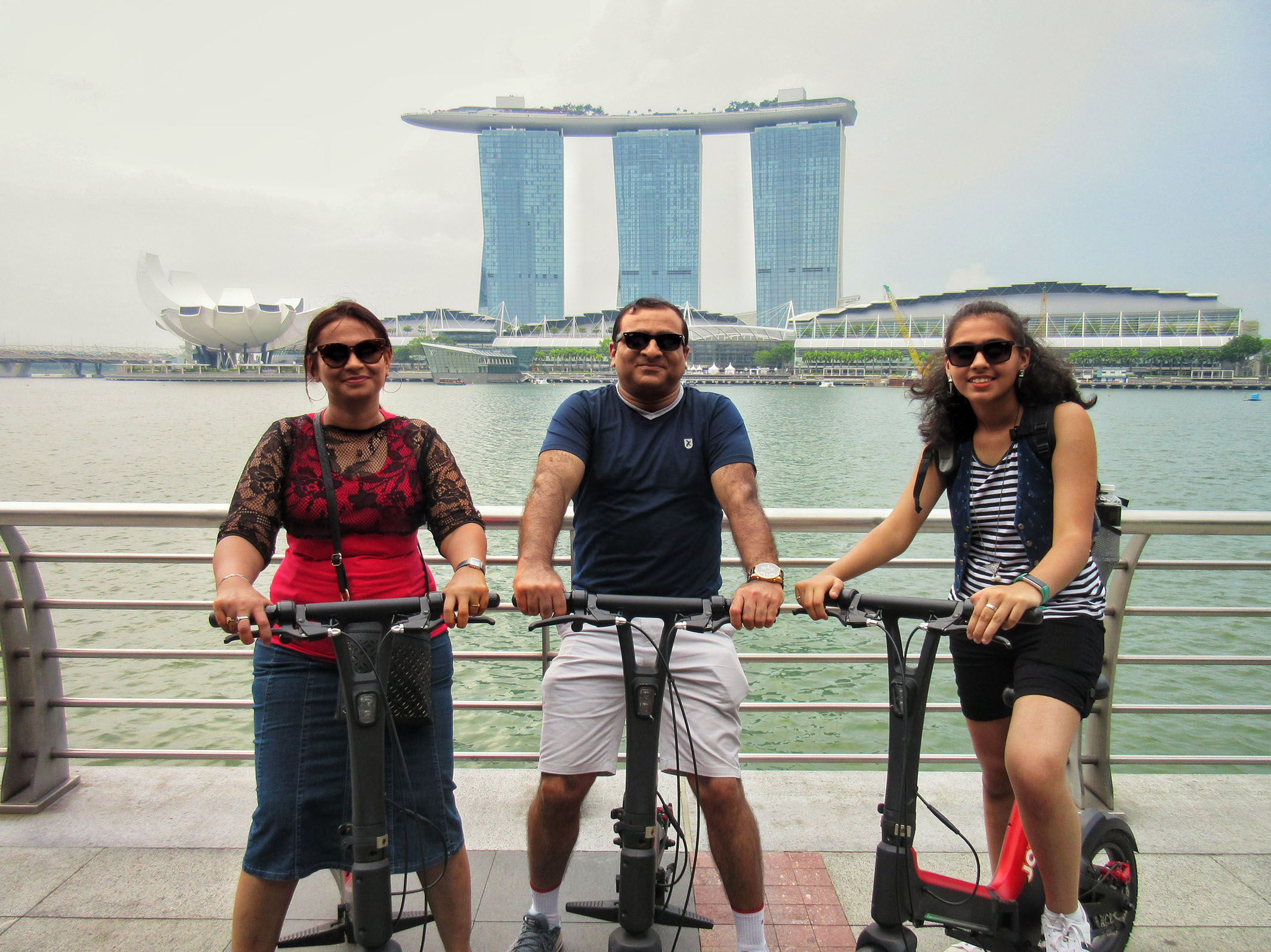 Having fun touring the city of Singapore on electric scooters at Marina Bay Sands.