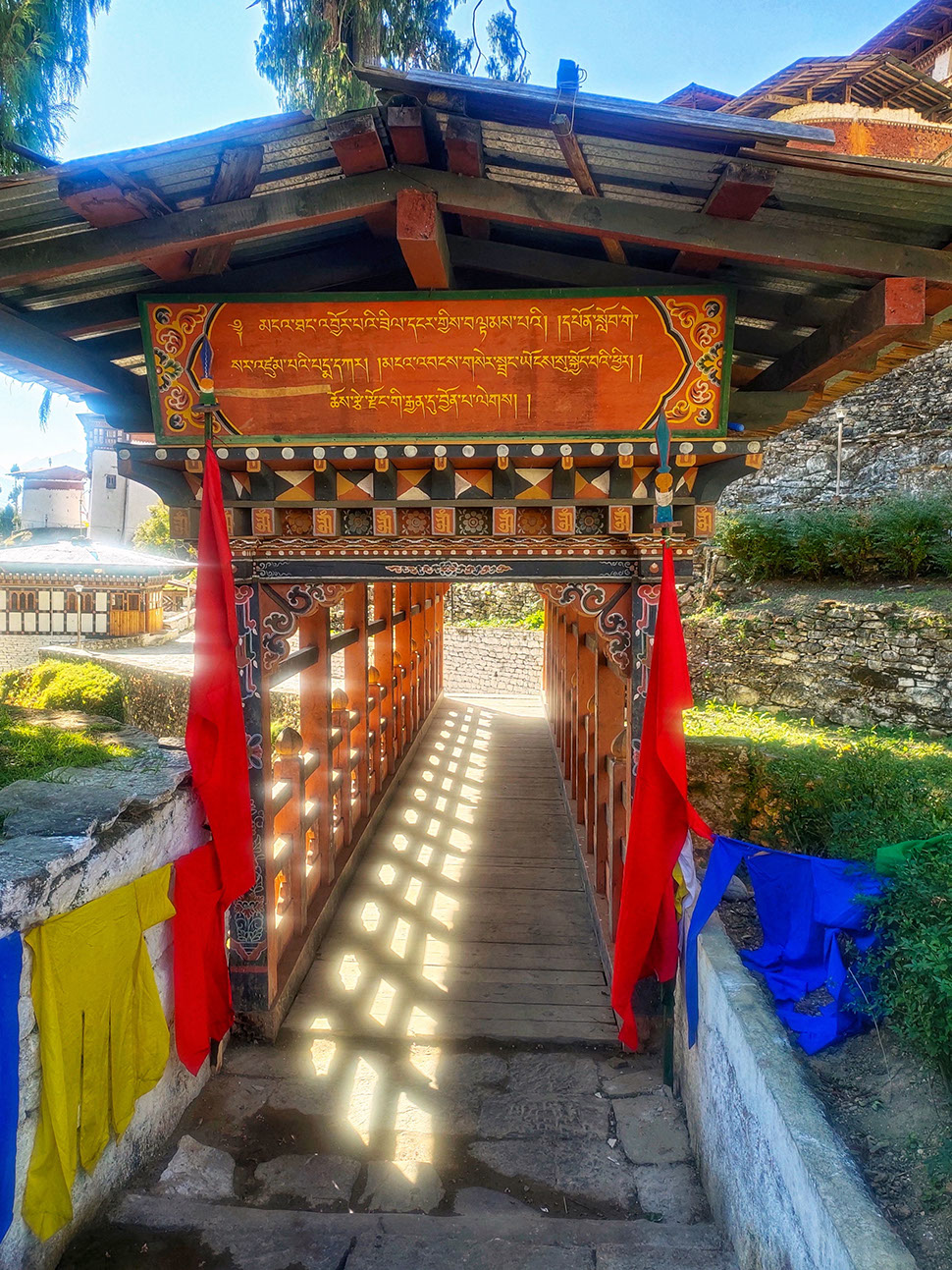 The wooden bridge entrance to Trongsa Dzong with decorative flags