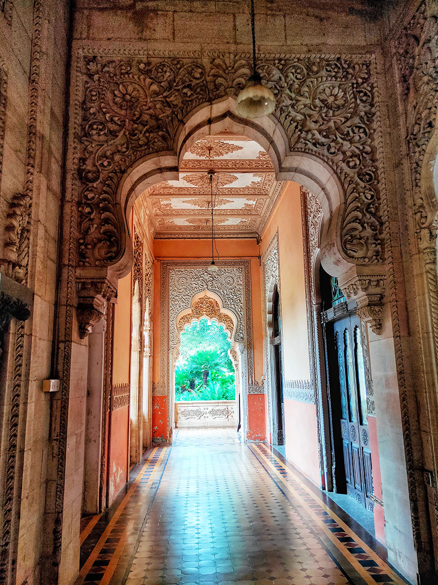 Intricately carved walls and pillars inside the corridors of Laxmi Vilas Palace