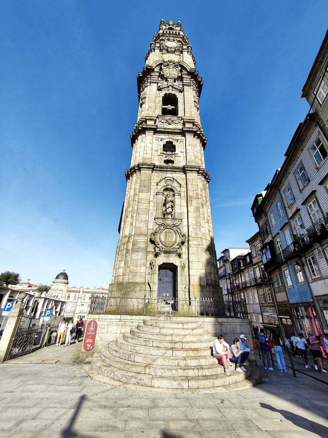 The iconic Torre dos Clerigos, towering majestically against Porto's bright blue skies