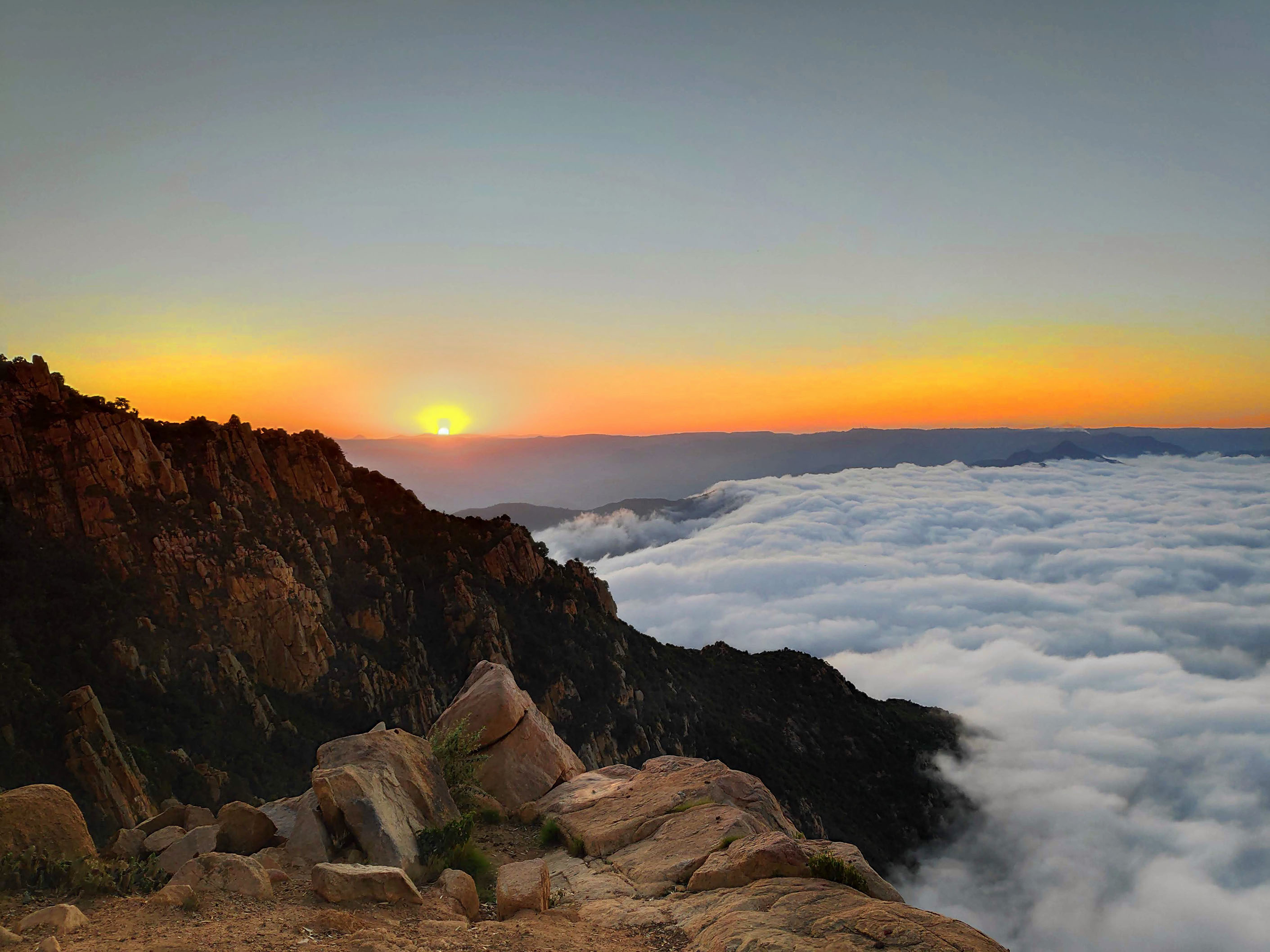 Sunset dipping into thick clouds below at 11,500 feet at Debre Bizen monastery in Eritrea