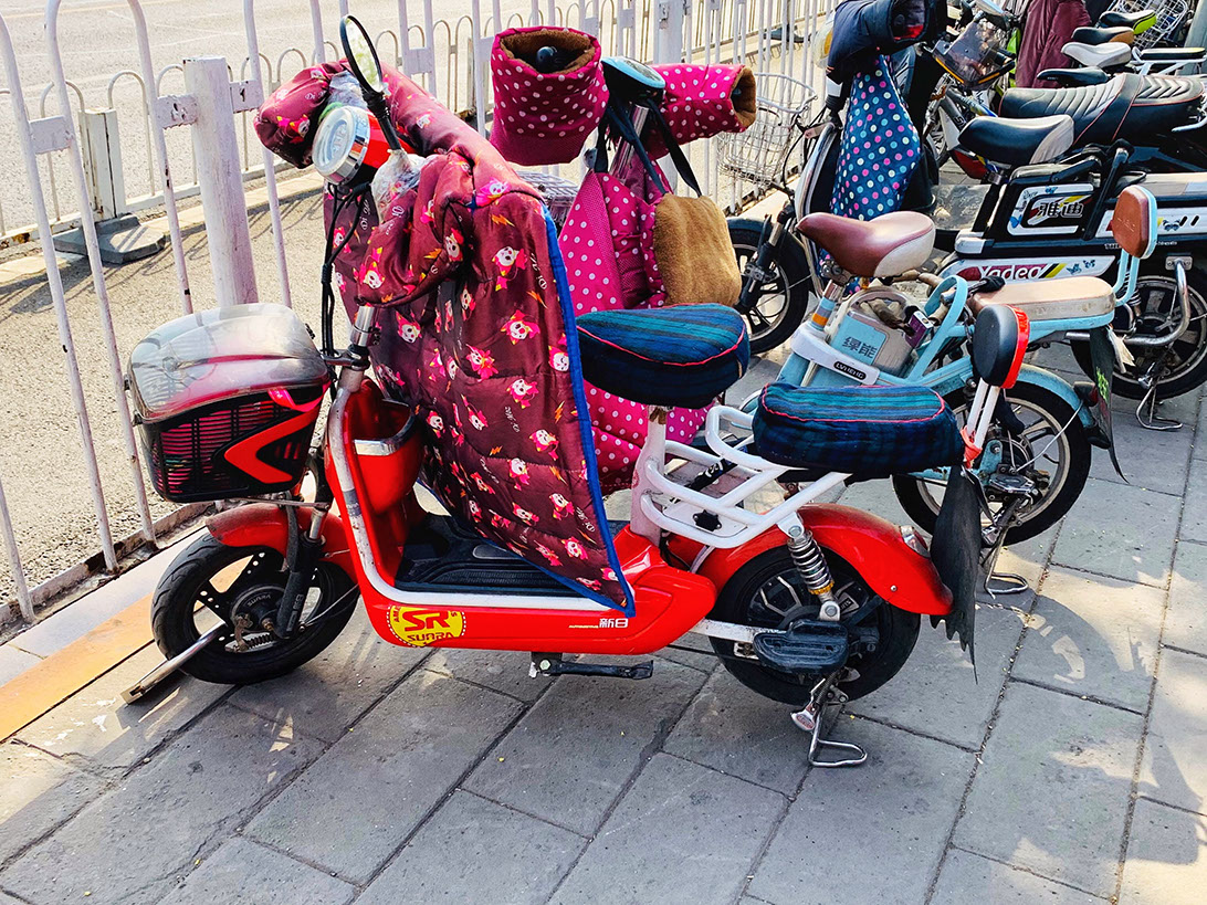 Scooters in Beijing are fitted with jackets