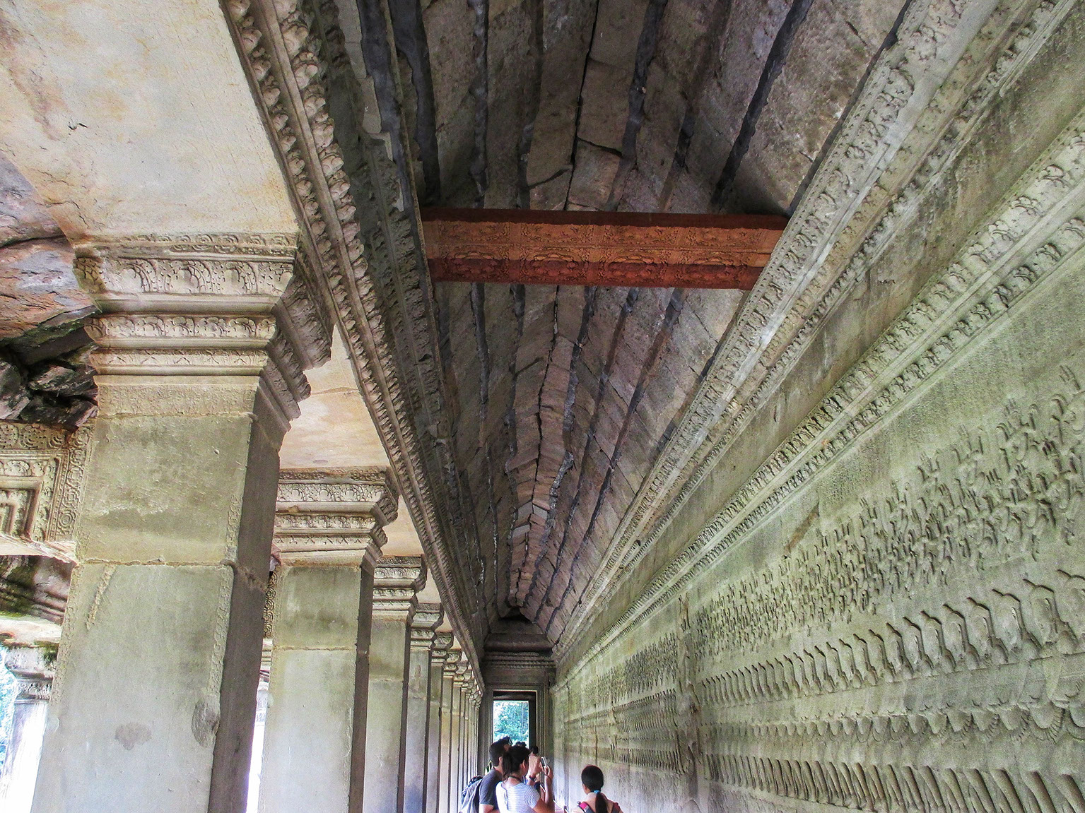 One of the many corridors in the gallery of Angkor Wat with decorated walls