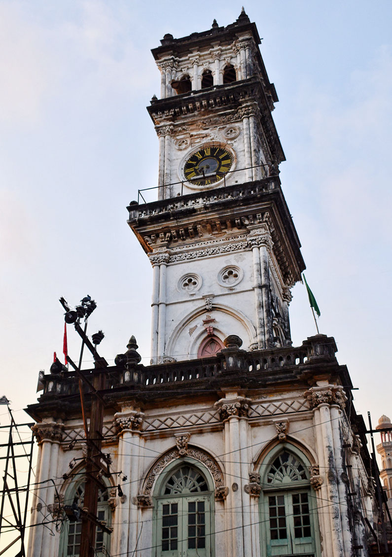 Mandvi Tower with a vintage clock and an arched doorway in the old city of Jamnagar