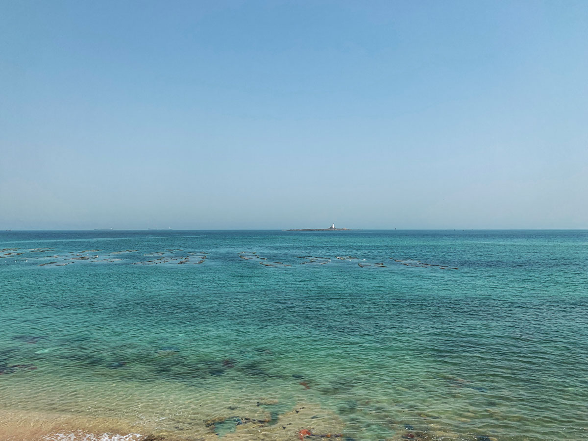 As the ocean hugs the shores of Okha, its turquoise waters provide a peaceful retreat