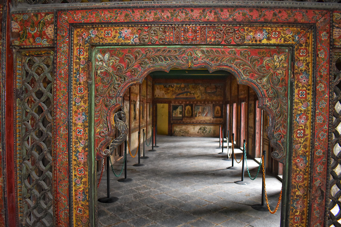 A carved wooden screen (Jharokha) on the first floor in Tambekar Wada with beautiful floral paintings