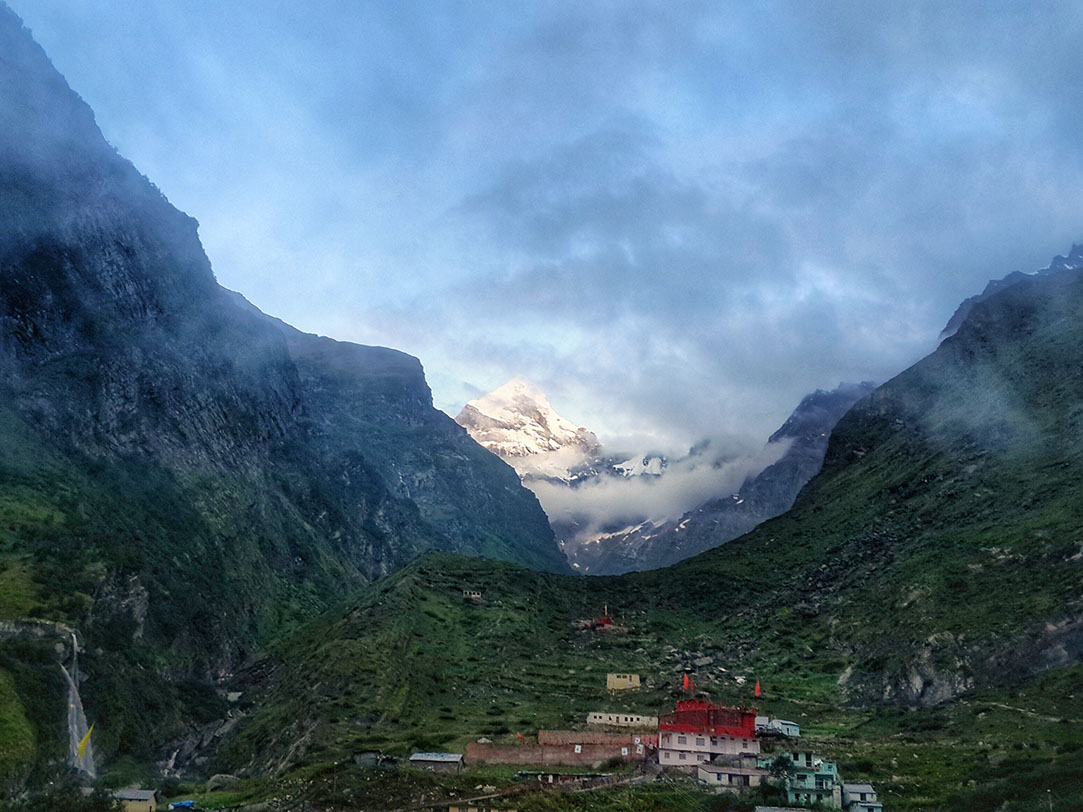 Stunning view of Badrinath temple surrounded by mountains and greenery