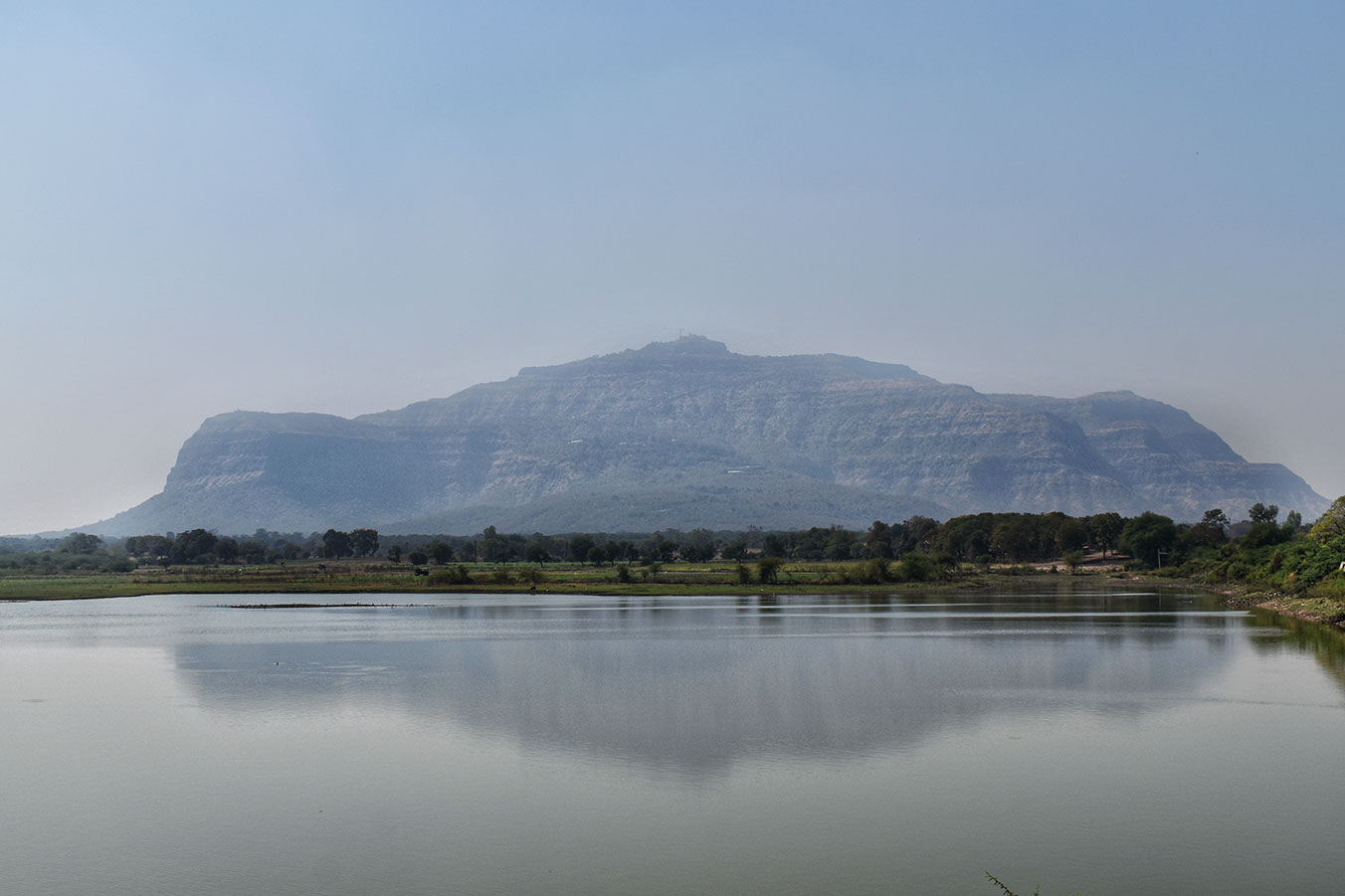 The tranquil surroundings of the Vadatalav lake with Pavagadh hills in the background