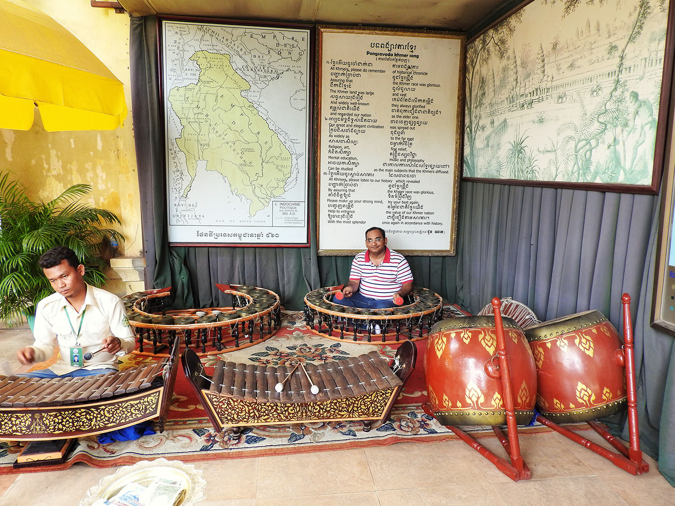 Devang trying his hands on one of the traditional Cambodian musical instruments inside the Royal Palace