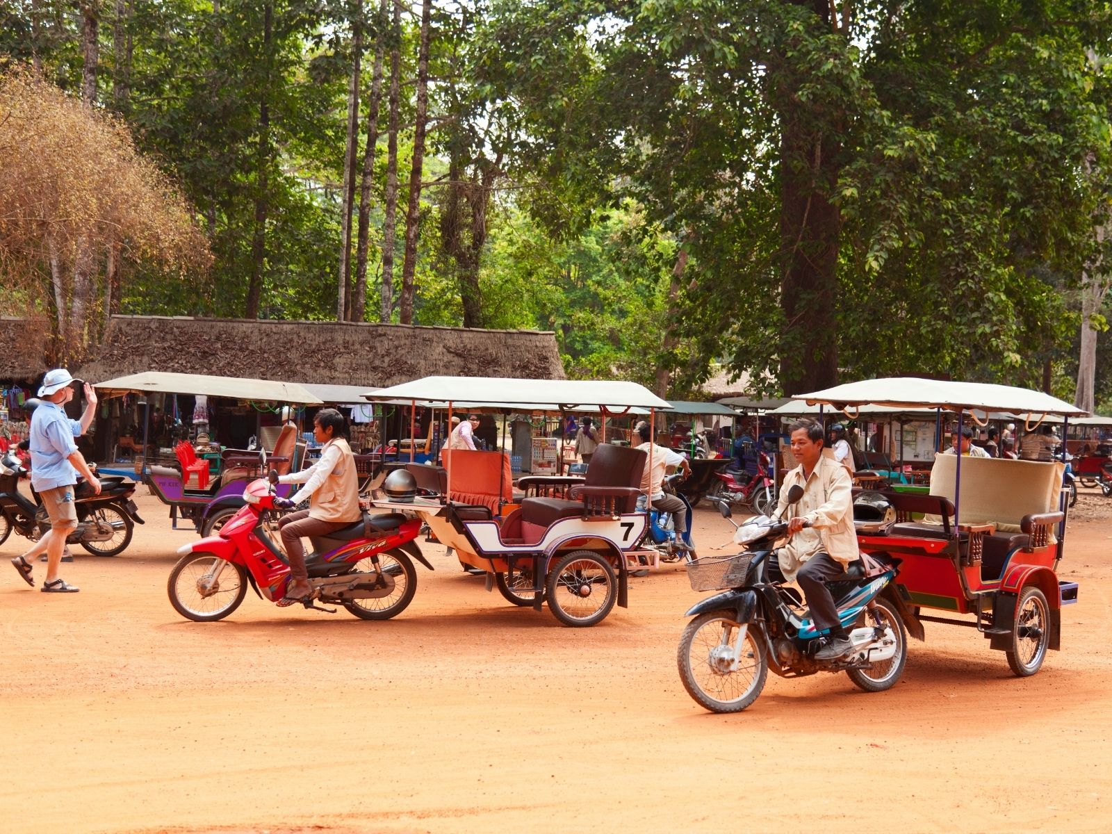 Tuk-Tuks waiting for tourists in and around Angkor Wat ticket office