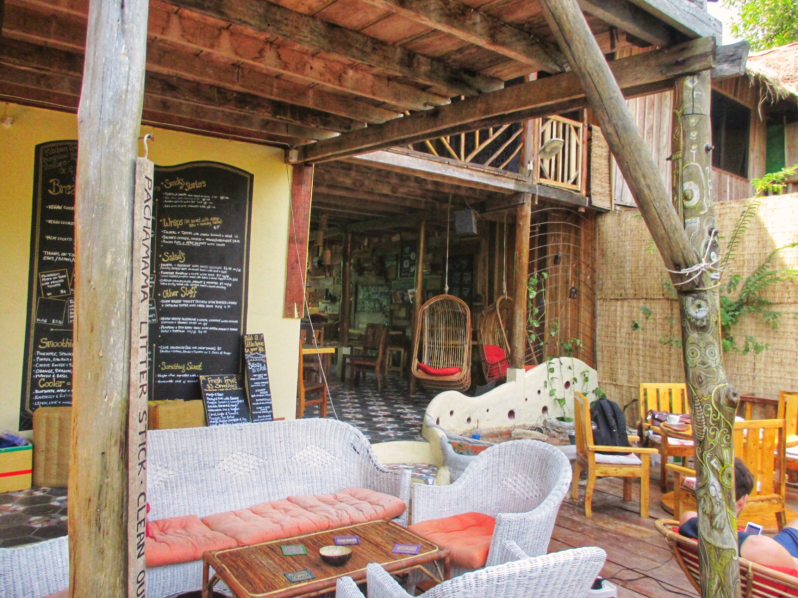Ambience at a Sihanoukville restaurant with its wooden structures, greenery and warm decor