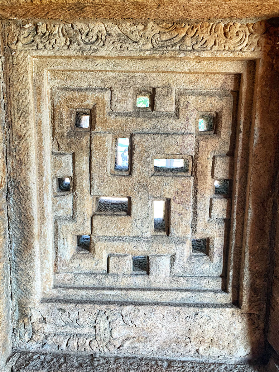 Beautifully carved "Swastika" in the window in Kadalingeshwara temple