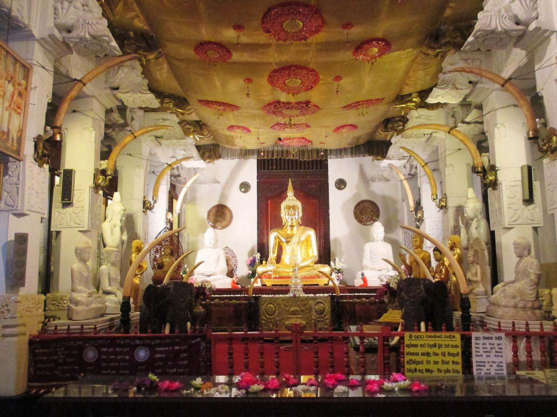 Statue of golden Buddha inside the Temple of Tooth Relic in Kandy Sri Lanka
