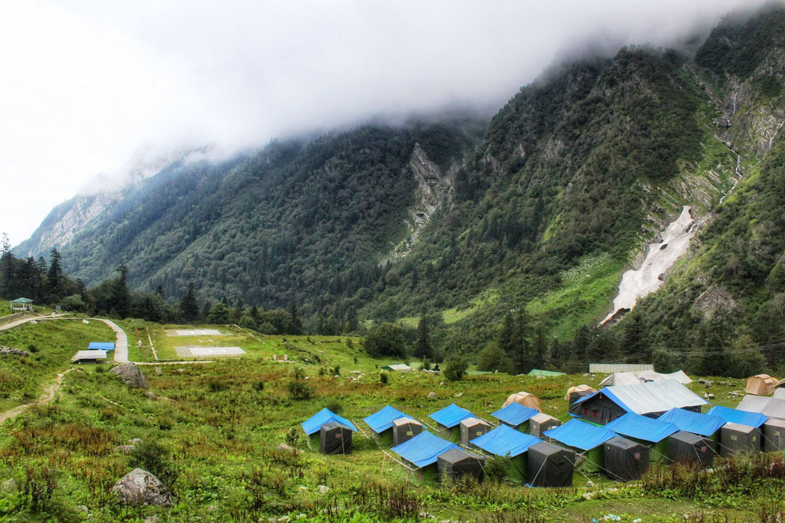 A view of Ghangaria village with its camping and mountains covered in lush greenery