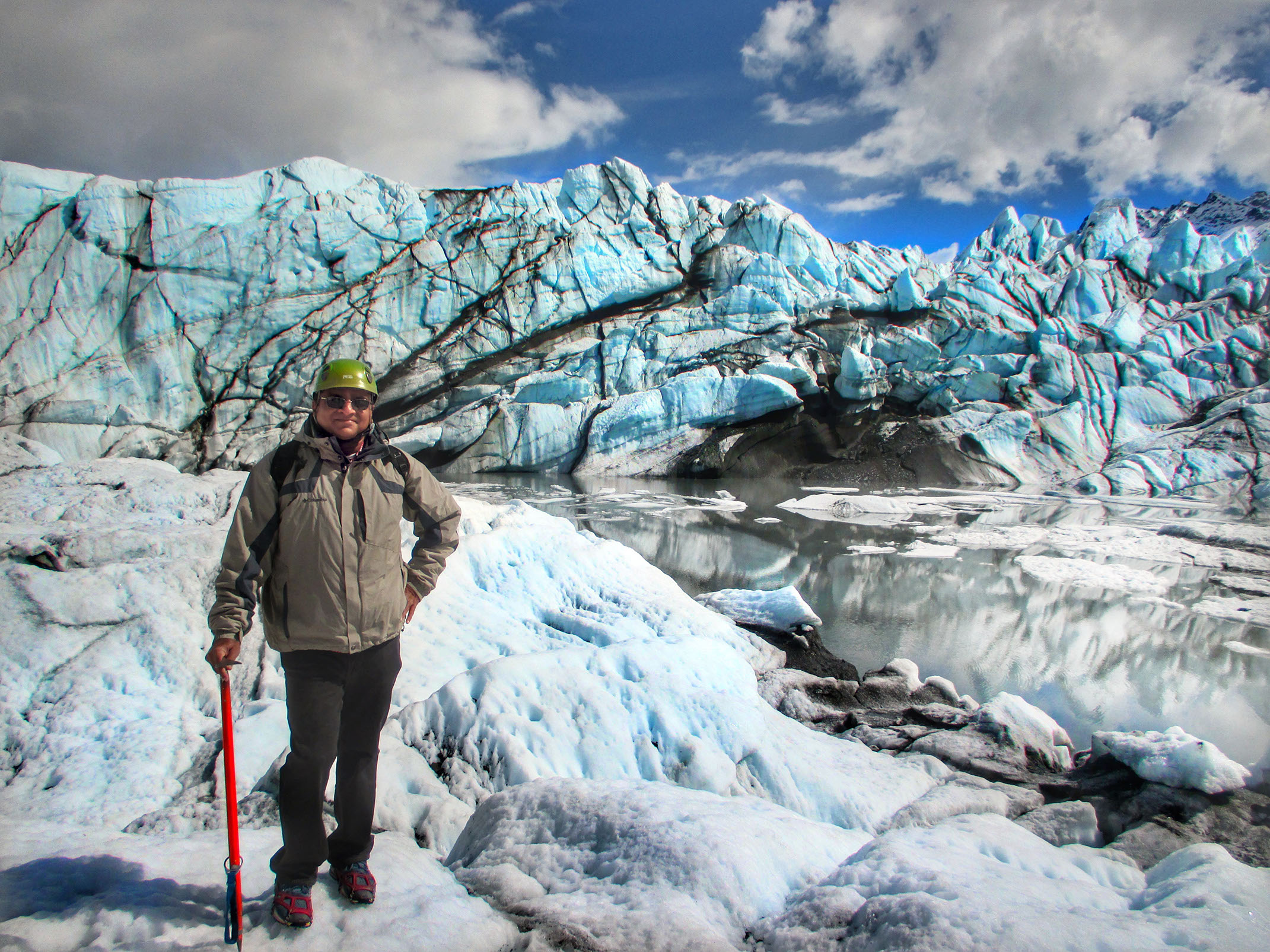 Here, Rahuldev Rajguru outfitted with helmet, crampons & ice axe in the middle of Matanuska glacier in Alaska