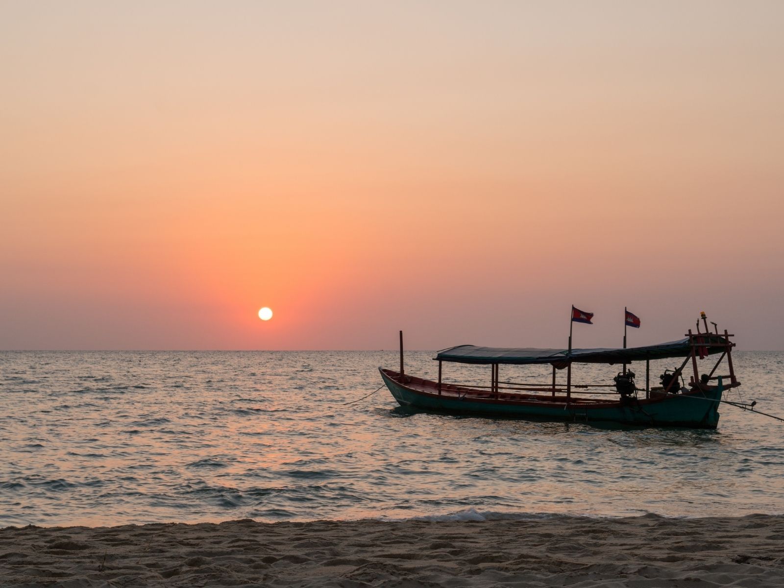 Sunset with floating boat in Otres beach